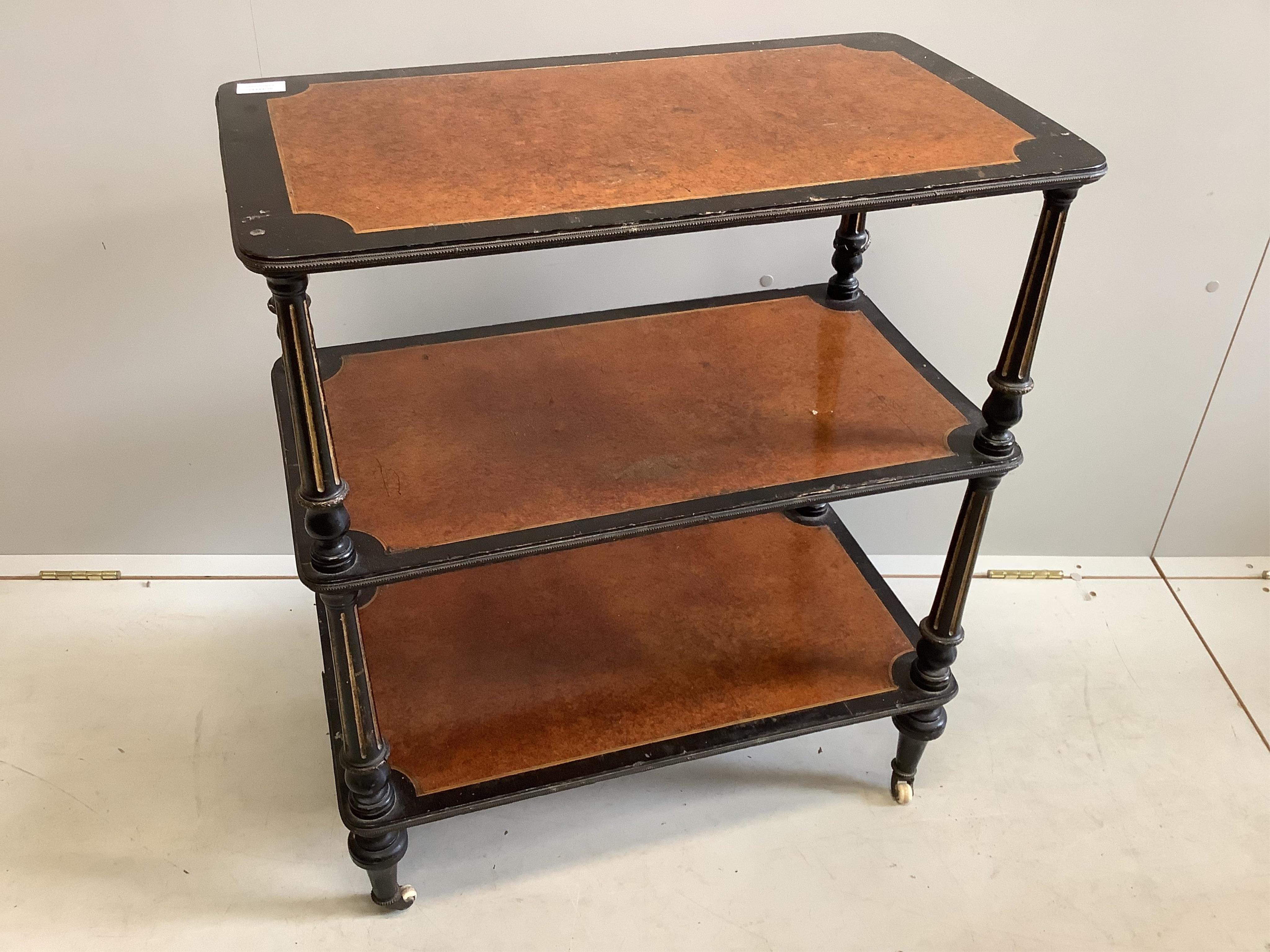 A late Victorian ebonised and amboyna three tier whatnot, width 66cm, depth 37cm, height 78cm. Condition - poor